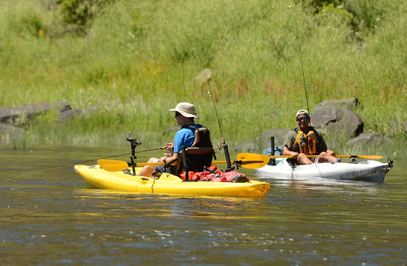 two men fishing and kayaking in a kayak on John Day River in Central Oregon