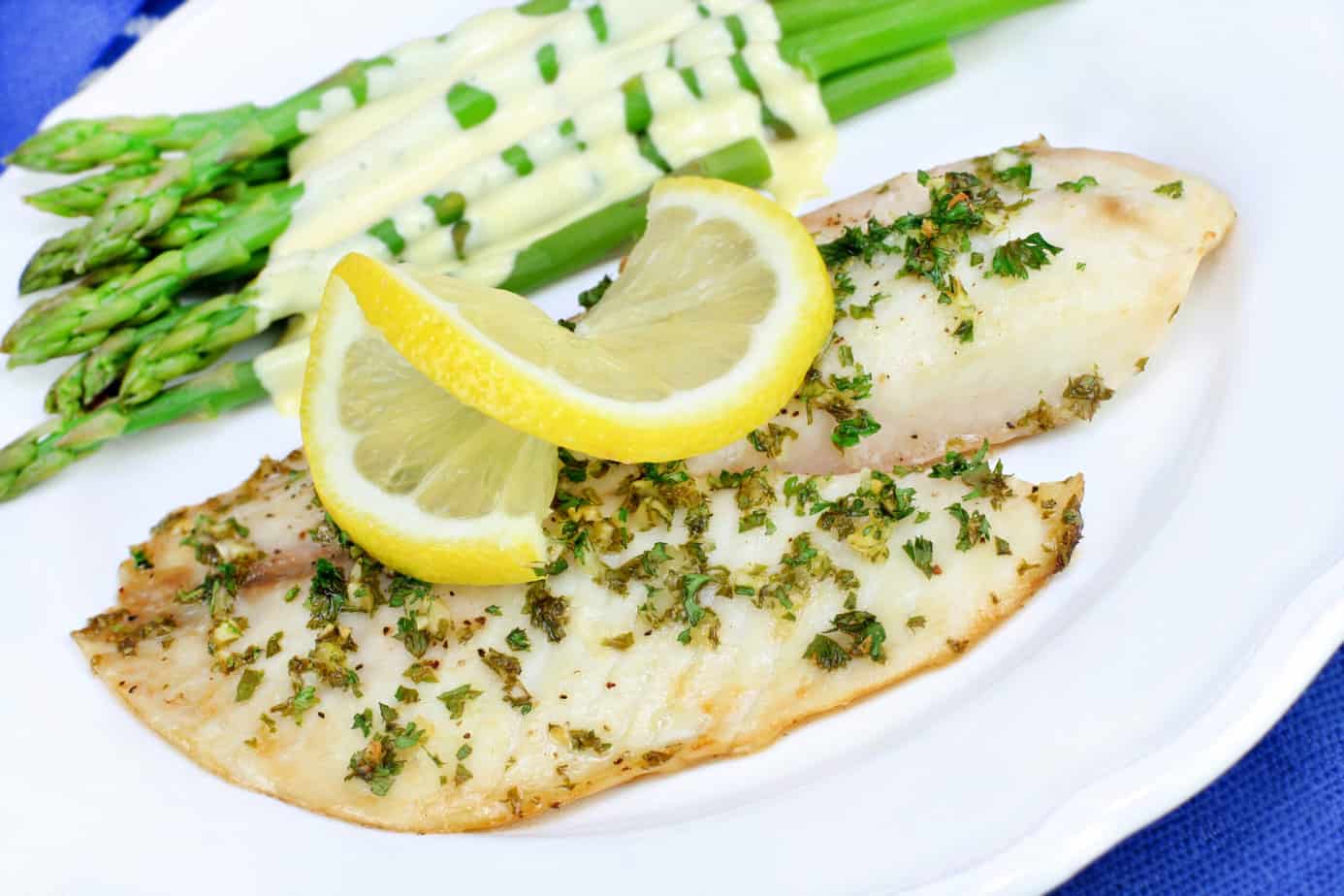 Fresh baked Tilapia fish dinner with asparagus and Hollandaise s